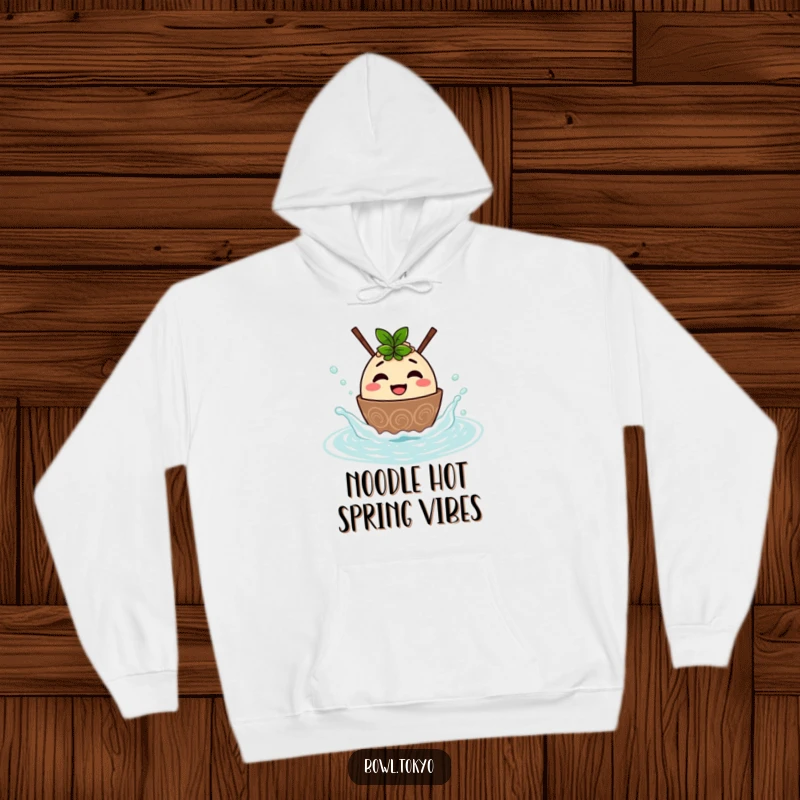 Funny hoodie with a cute ramen bowl character splashing in a hot spring, offering warmth and a humorous, joyful vibe.