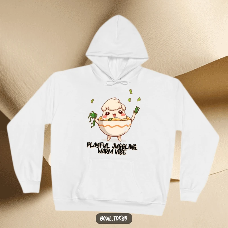 Funny Cozy Ramen Bowl Hoodie featuring a playful character juggling tiny seaweed pieces, blending comfort with fun.